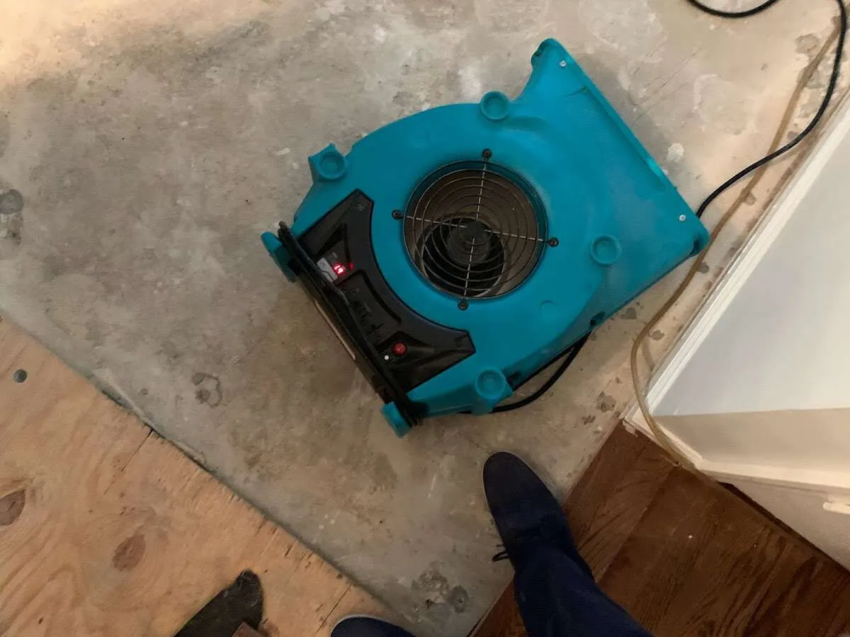 Air mover drying subfloor during Commercial Water Damage Restoration in Prosser